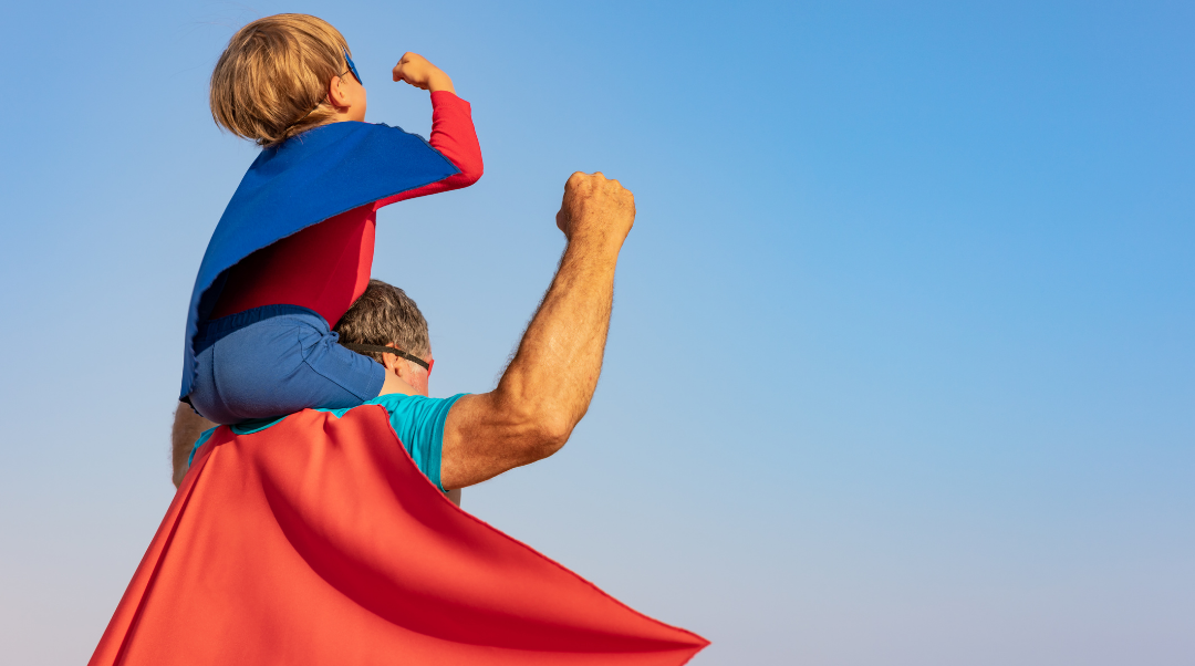 Boy Riding Dads Shoulders Wearing Capes